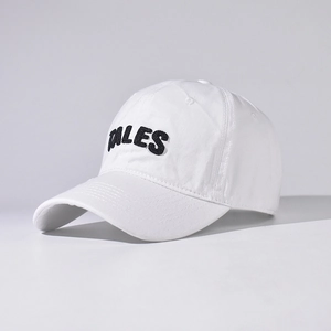 Close-up of black TALES 3D embroidery on a white cotton baseball cap with seam details