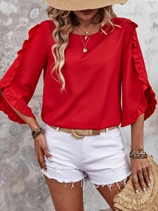 Women stylish red ruffle sleeve top paired with white distressed denim shorts