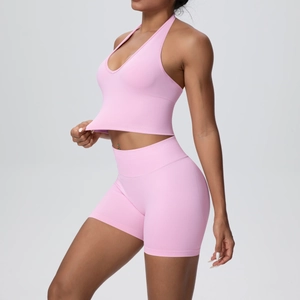 Pink halter yoga bra and high-waist shorts set shown in a 45-degree profile view