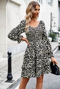Detail of a floral V-neck long sleeve dress with tiered ruffle hem and high waist design