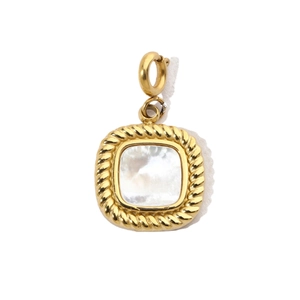 Macro detail of gold vintage square pendant featuring natural white shell inlay texture