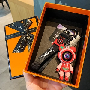 Creative astronaut keychain gift set in elegant orange box with black ribbon and wrist strap