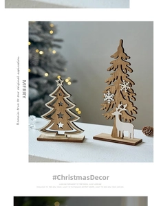Close-up of wooden Christmas tree ornaments with reindeer and snowflake details