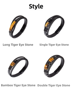 Detail view of multi-layer black leather bracelets with diverse tiger eye stone accents