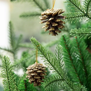 Golden glitter pine cone Christmas tree ornaments with hanging string on branches