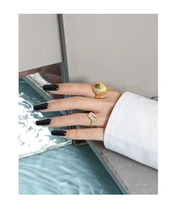 Detail of S925 sterling silver sunflower rings on model with water reflection art