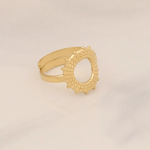 Detail of gold-plated adjustable ring with open hollow design and beaded textures