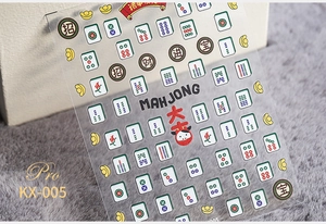 Macro shot of 5D mahjong nail art stickers featuring gold ingots and lucky characters