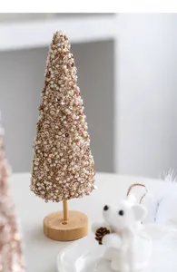 Detail of mini gold sequin Christmas tree with white pearls and natural wood base