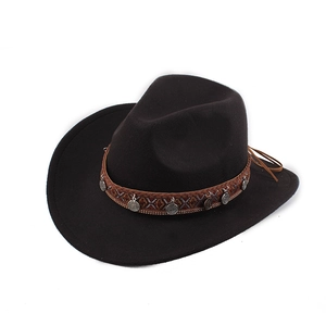 Detailed view of black felt cowboy hat featuring ethnic woven band and silver pendants