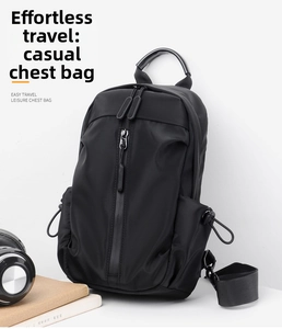 Detail view of water-resistant black crossbody chest bag with vertical zipper and side pockets