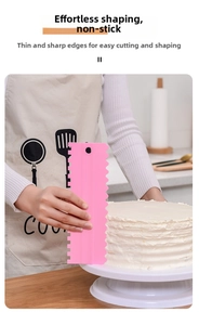 Action shot of pink jagged cake scraper smoothing cream on a cake in a home kitchen