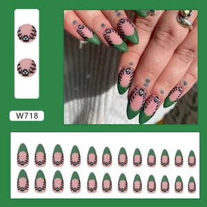 Matte dark green French almond press-on nails with black leaf design and skull accents