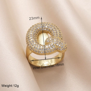Detailed view of gold letter Q ring with pavé zircons including size and weight specs