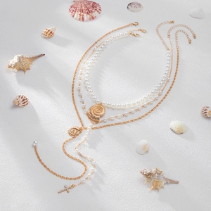 3-piece layered gold necklace set with pearls, sea shell and cross pendant