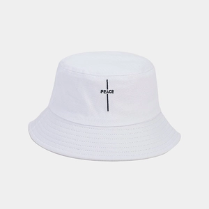 Detail of black PEACE embroidery and reinforced stitching on white cotton bucket hat