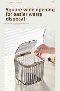 Detail view of the sleek grey desktop trash can with textured stripes and flip-top lid