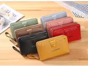 Detail view of colorful faux leather wristlet wallets showing zipper and card pocket