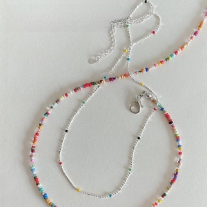 Detail of multi-layered S925 silver necklace with vibrant colorful beads and lobster clasp