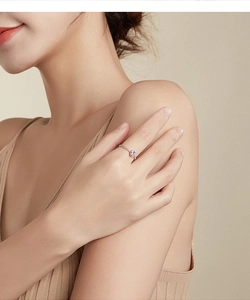 Close-up of heart-shaped pink crystal ring with micro-pave diamonds on silver band