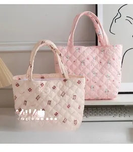 Detailed view of quilted cotton tote bags featuring cute cartoon patterns and diamond stitching