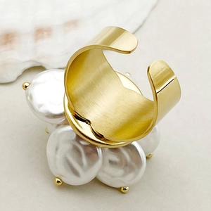 Macro view of gold-plated flower ring with baroque pearls and brushed metal finish