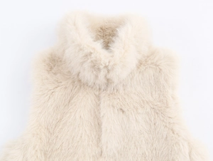 Close-up detail of soft beige faux fur vest showing plush texture and premium fibers