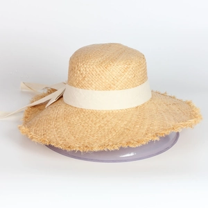 Wide brim raffia straw sun hat with beige ribbon bow and fringe edge for summer beach