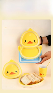 Detailed set of cute yellow duck kids dinnerware with divided plate bowl and cup