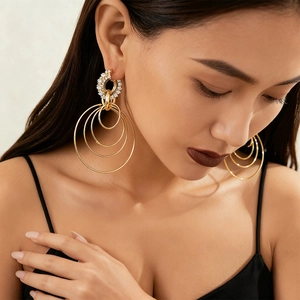 Exaggerated golden multi-layered geometric hoop earrings with sparkling rhinestones