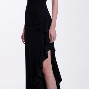 Detail view of the black one-piece swimsuit featuring a side ruffle slit and high-end fabric