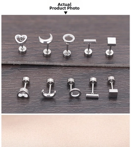 Macro view of geometric stainless steel earrings in heart and moon shapes