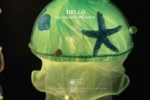 Close-up of LED jellyfish lamp with green tulle ribbons, starfish and pearl details