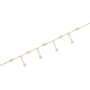 Macro detail of gold-plated anklet featuring round cubic zirconia stone charms