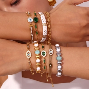 Macro view of multi-layer evil eye bracelets with green stones and sparkling crystals