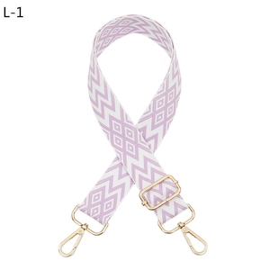 Detail of adjustable purple and white geometric jacquard strap with gold metal hooks