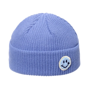 Light blue knit beanie hat with smiling face patch and ribbed winter warm texture