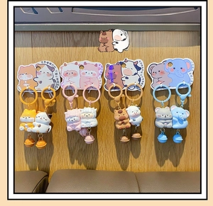 Detail of cute animal couple keychains with magnetic resin charms and colorful bells