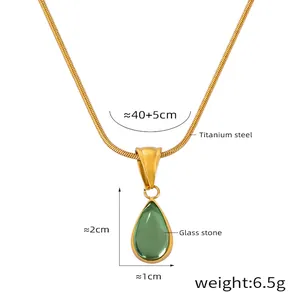 Detail view of gold snake chain and green teardrop pendant with dimensions measurements