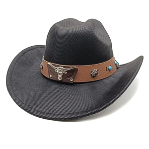 Detail of western cowboy hat featuring silver bull head emblem and turquoise studs on band