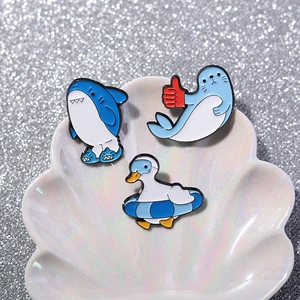 Cute enamel shark duck and seal cartoon animal pins set on a decorative shell plate