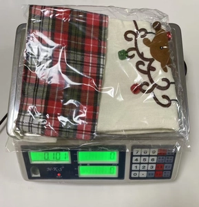 Detail of Christmas burlap stockings with reindeer applique on a digital scale for weight