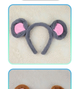 Close-up of gray and brown plush mouse ears headbands on vintage lace background