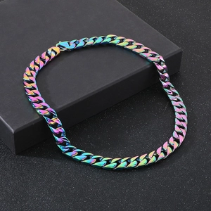 Macro detail of 15mm rainbow gradient cuban link chain on a matte black gift box
