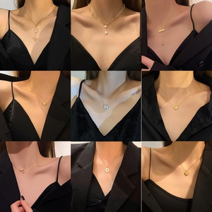 Collection of nine gold titanium steel necklaces featuring heart and pearl pendants