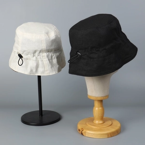 Detail of linen bucket hat showing breathable texture and adjustable drawstring buckle