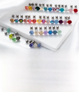 Macro detail of multicolored cubic zirconia titanium steel studs with size specifications