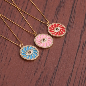 Detail of three gold evil eye necklaces with red pink and blue enamel and crystals
