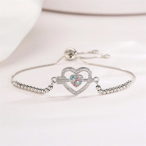 Detailed macro view of heart-shaped silver bracelet with colorful cubic zirconia stones