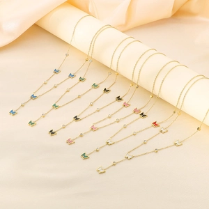 Detail of colorful butterfly pendants on gold stainless steel necklaces with zircons